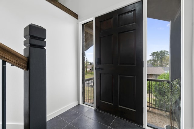 7 Buttermilk Rd, Little Rock, AR 72227 - entryway with dark tile patterned floors and baseboards