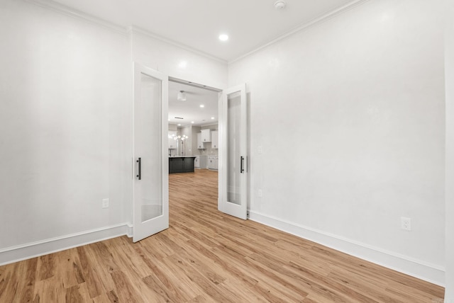 unfurnished room with light wood-type flooring, baseboards, crown molding, and recessed lighting