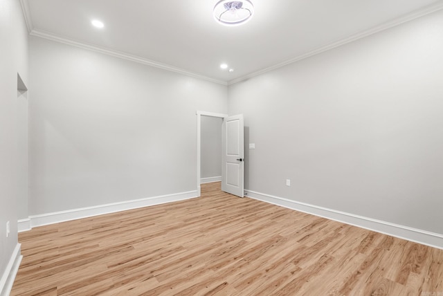 empty room with crown molding, light wood-style floors, baseboards, and recessed lighting