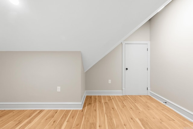 bonus room featuring lofted ceiling, wood finished floors, and baseboards