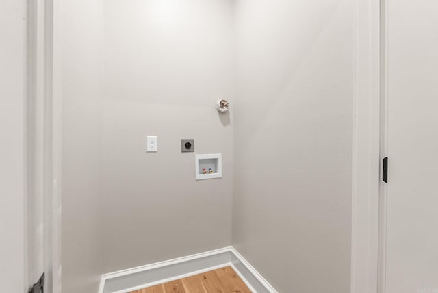 washroom with electric dryer hookup, baseboards, light wood finished floors, and hookup for a washing machine