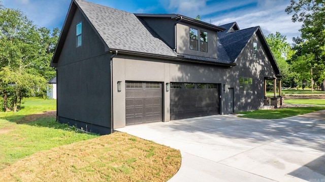 view of property exterior featuring a shingled roof, a lawn, concrete driveway, and stucco siding