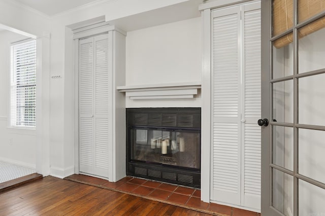 1810 S Pierce St, Little Rock, AR 72204 - detailed view of wood finished floors, ornamental molding, baseboards, and a glass covered fireplace