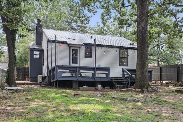 1810 S Pierce St, Little Rock, AR 72204 - rear view of house with a chimney, metal roof, and a wooden deck
