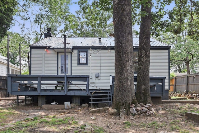 1810 S Pierce St, Little Rock, AR 72204 - rear view of house with a wooden deck, metal roof, and a chimney