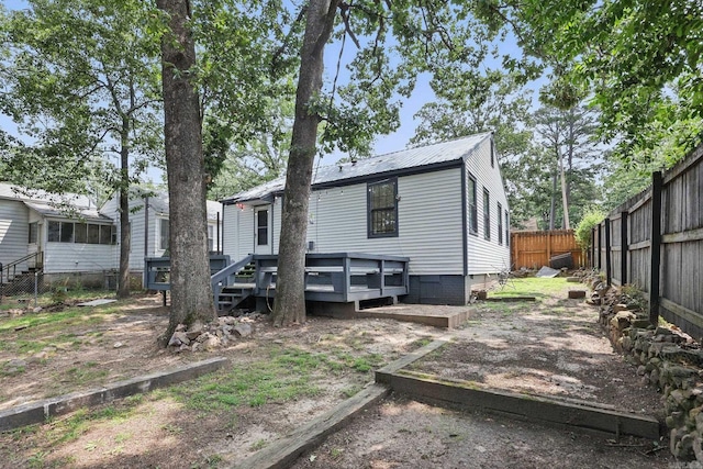 1810 S Pierce St, Little Rock, AR 72204 - rear view of house featuring a fenced backyard, metal roof, and a deck