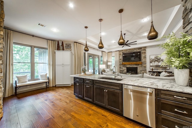 43 Mikes Cir, Heber Springs, AR 72543 - kitchen with dishwasher, a sink, a fireplace, dark brown cabinetry, and a ceiling fan
