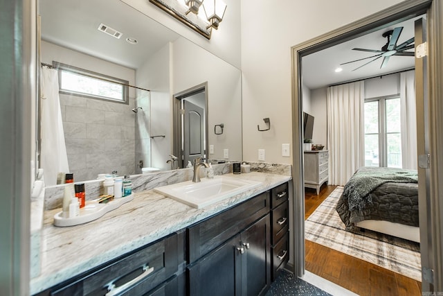 43 Mikes Cir, Heber Springs, AR 72543 - ensuite bathroom with healthy amount of natural light, wood finished floors, vanity, and curtained shower