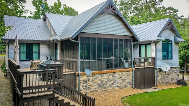 43 Mikes Cir, Heber Springs, AR 72543 - back of house featuring a sunroom, metal roof, and stairway