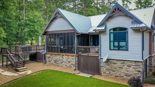 43 Mikes Cir, Heber Springs, AR 72543 - rear view of house with stone siding, a sunroom, stairs, a wooden deck, and metal roof