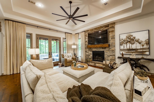 43 Mikes Cir, Heber Springs, AR 72543 - living room featuring a raised ceiling, french doors, a fireplace, a ceiling fan, and wood finished floors