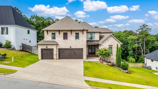 67 Falstone Dr, Little Rock, AR 72223 - french country style house featuring an attached garage, concrete driveway, roof with shingles, and brick siding