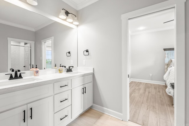 67 Falstone Dr, Little Rock, AR 72223 - ensuite bathroom with double vanity, crown molding, baseboards, and wood finished floors