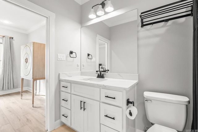 67 Falstone Dr, Little Rock, AR 72223 - bathroom with vanity, ornamental molding, toilet, wood finished floors, and baseboards