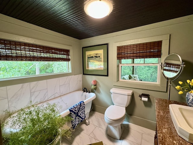 2645 Jumbo Rd, Melbourne, AR 72556 - bathroom with a soaking tub, marble look tiles, toilet, baseboards, and vanity