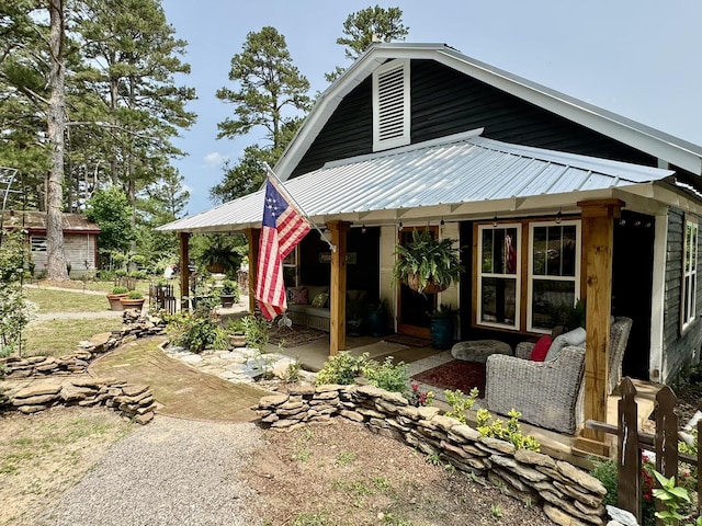 2645 Jumbo Rd, Melbourne, AR 72556 - view of side of home featuring metal roof and a patio