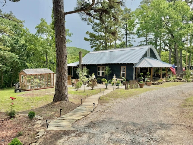 2645 Jumbo Rd, Melbourne, AR 72556 - view of front of house with an outbuilding and metal roof