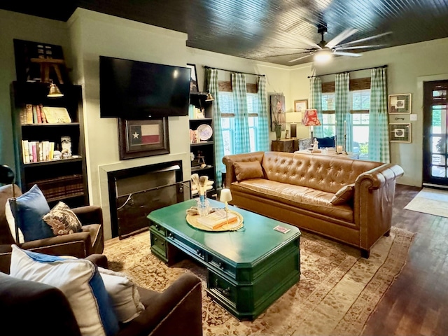 2645 Jumbo Rd, Melbourne, AR 72556 - living room with wood finished floors, a ceiling fan, a fireplace, and built in shelves