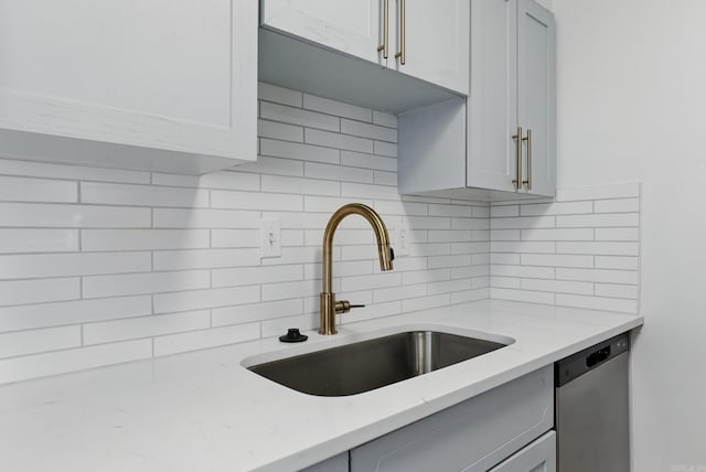 700 E 9th J St, Little Rock, AR 72202 - kitchen featuring a sink, dishwasher, tasteful backsplash, gray cabinets, and light stone countertops