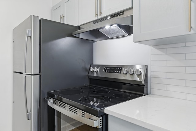 700 E 9th J St, Little Rock, AR 72202 - kitchen featuring stainless steel electric stove, under cabinet range hood, tasteful backsplash, white cabinetry, and light stone counters