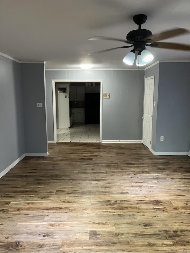 5006 Manor Ave, Little Rock, AR 72204 - empty room with crown molding, wood finished floors, a ceiling fan, and baseboards