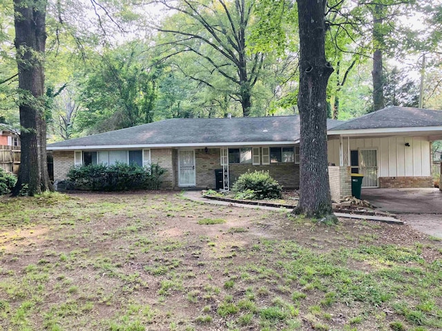 5006 Manor Ave, Little Rock, AR 72204 - ranch-style home featuring brick siding, a carport, and concrete driveway