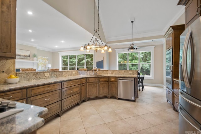 34 Chemin Ct, Little Rock, AR 72223 - kitchen featuring appliances with stainless steel finishes, ornamental molding, tasteful backsplash, recessed lighting, and pendant lighting