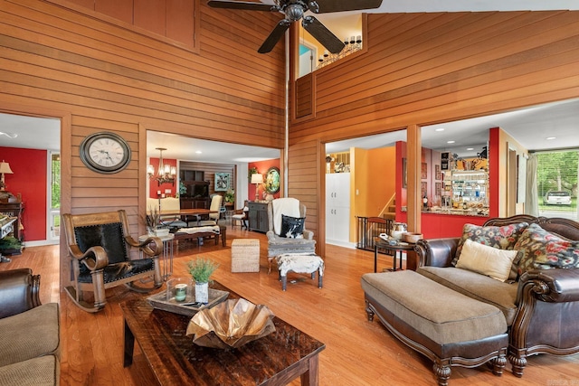 19 Privett Park Dr, Lonoke, AR 72086 - living area featuring wooden walls, a ceiling fan, a towering ceiling, stairs, and wood finished floors