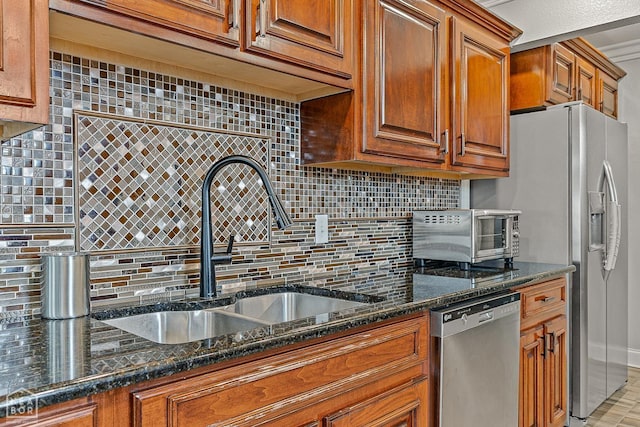 3117 Meador Ave, Jonesboro, AR 72401 - kitchen featuring stainless steel appliances, a sink, backsplash, and brown cabinets