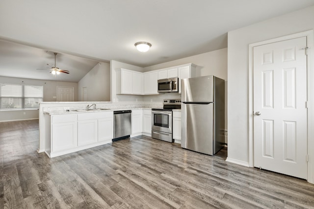 6096 Saddle Hill Dr, Alexander, AR 72002 - kitchen with appliances with stainless steel finishes, a peninsula, white cabinetry, ceiling fan, and wood finished floors