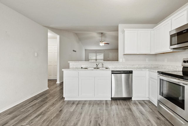 6096 Saddle Hill Dr, Alexander, AR 72002 - kitchen featuring stainless steel appliances, vaulted ceiling, a sink, light wood finished floors, and a ceiling fan