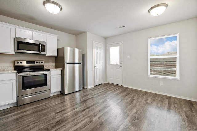 6096 Saddle Hill Dr, Alexander, AR 72002 - kitchen featuring stainless steel appliances, dark wood-type flooring, white cabinetry, and baseboards