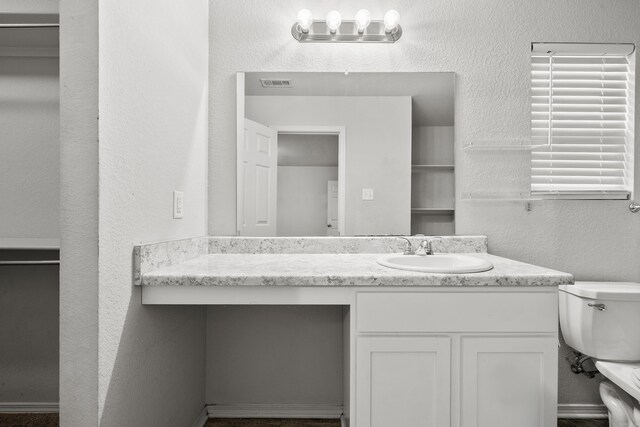 6096 Saddle Hill Dr, Alexander, AR 72002 - bathroom with toilet, vanity, and a textured wall