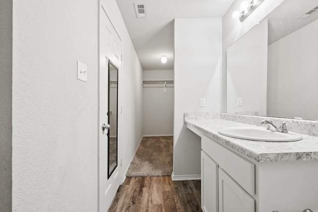 6096 Saddle Hill Dr, Alexander, AR 72002 - bathroom featuring vanity, wood finished floors, and baseboards