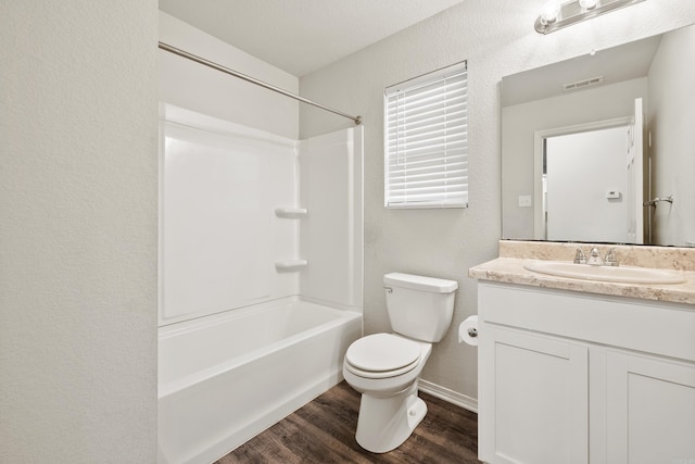 6096 Saddle Hill Dr, Alexander, AR 72002 - bathroom featuring vanity, wood finished floors, toilet, a textured wall, and washtub / shower combination