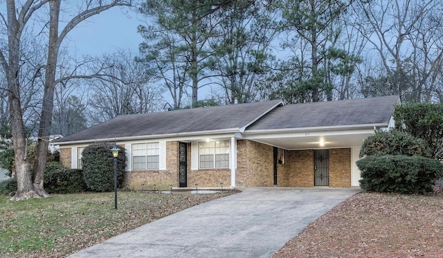 817 Ouachita Pl, Little Rock, AR 72205 - ranch-style house featuring brick siding, driveway, a carport, and roof with shingles