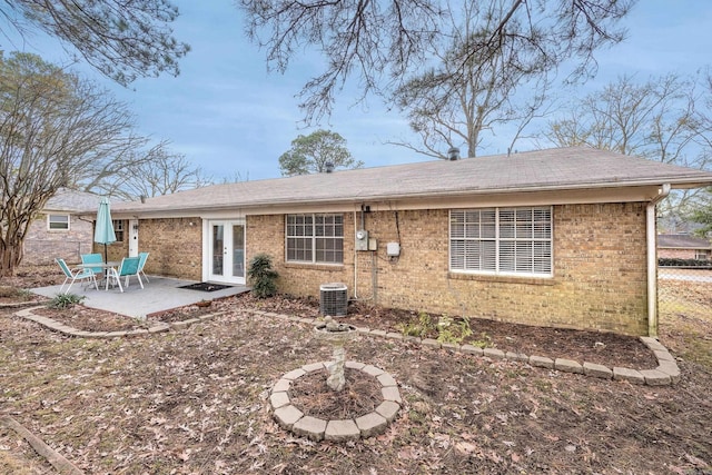 817 Ouachita Pl, Little Rock, AR 72205 - back of property with french doors, brick siding, a patio, a shingled roof, and central air condition unit