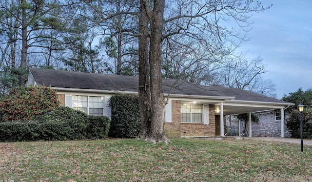 817 Ouachita Pl, Little Rock, AR 72205 - view of front of property with brick siding, a carport, a front lawn, and driveway