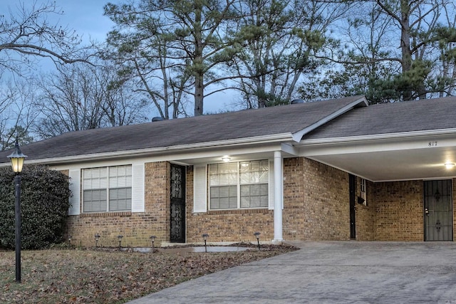 817 Ouachita Pl, Little Rock, AR 72205 - view of front facade with brick siding, a carport, and concrete driveway