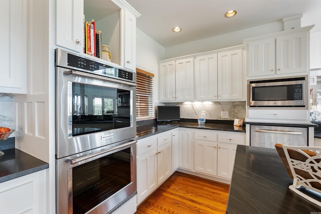 4501 Ridgefield Ln, Little Rock, AR 72223 - kitchen featuring stainless steel appliances, dark countertops, white cabinets, and recessed lighting