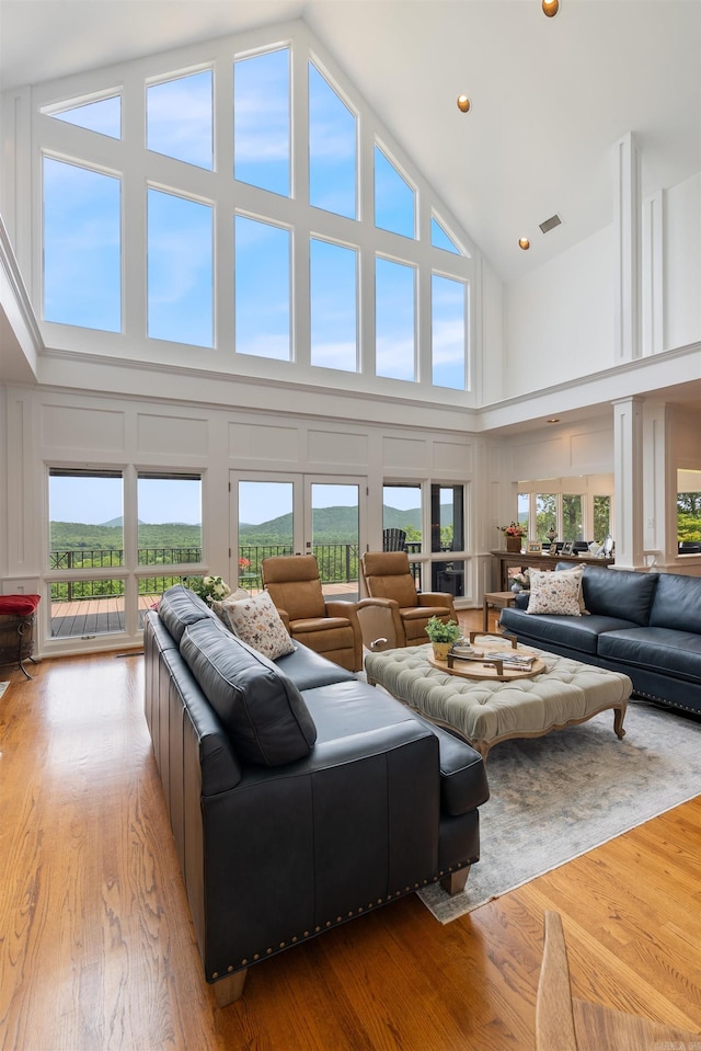 4501 Ridgefield Ln, Little Rock, AR 72223 - living area featuring high vaulted ceiling, wood finished floors, and a decorative wall