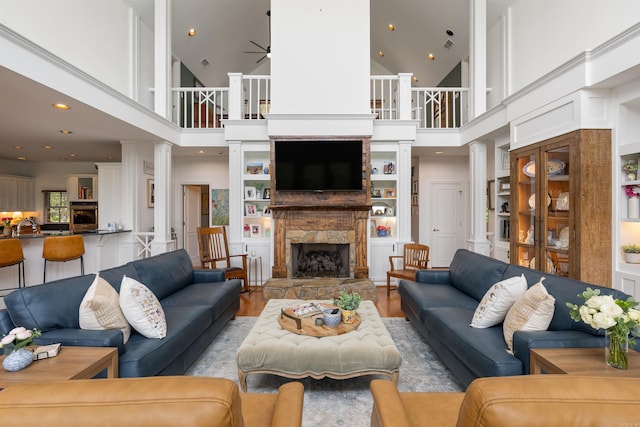 4501 Ridgefield Ln, Little Rock, AR 72223 - living room featuring a stone fireplace, ceiling fan, high vaulted ceiling, wood finished floors, and recessed lighting
