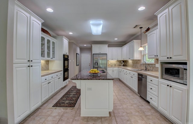 9 Lanes End, Little Rock, AR 72223 - kitchen featuring appliances with stainless steel finishes, a sink, ornamental molding, white cabinets, and backsplash