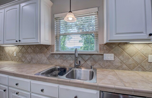 9 Lanes End, Little Rock, AR 72223 - kitchen featuring a sink, white cabinetry, hanging light fixtures, and dishwasher