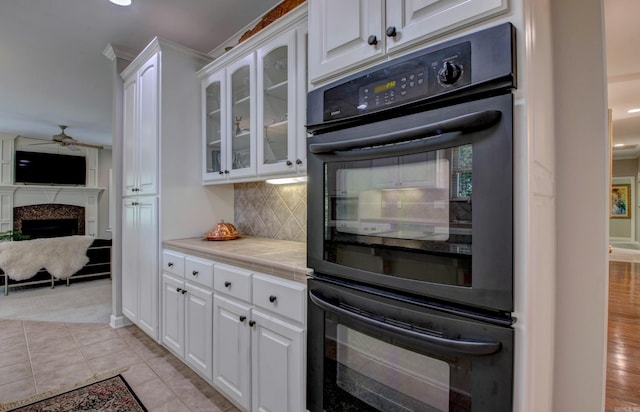 9 Lanes End, Little Rock, AR 72223 - kitchen with white cabinets, glass insert cabinets, tasteful backsplash, a ceiling fan, and recessed lighting