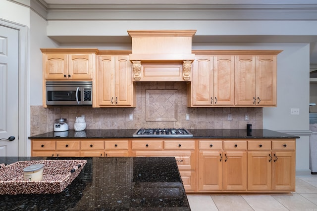 22 Epernay Cir, Little Rock, AR 72223 - kitchen with stainless steel appliances, light brown cabinets, dark stone countertops, light tile patterned floors, and ornamental molding