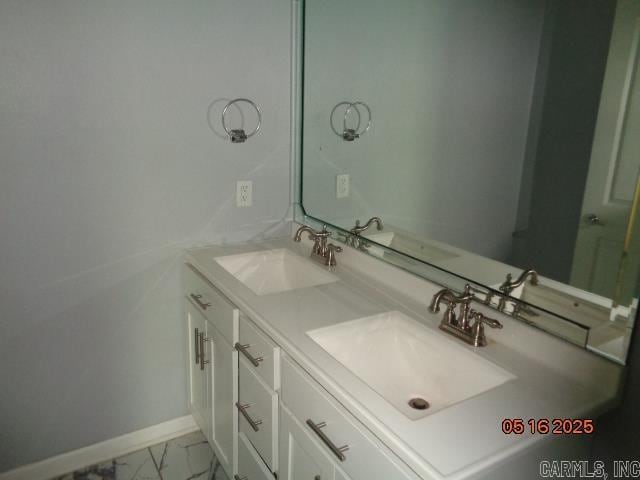 3122 Main St, Little Rock, AR 72206 - bathroom with baseboards, double vanity, and marble look tile flooring