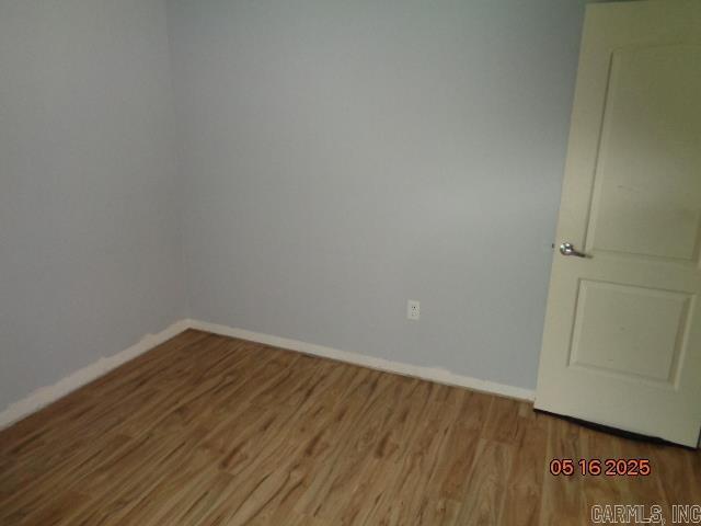3122 Main St, Little Rock, AR 72206 - empty room with wood finished floors and baseboards