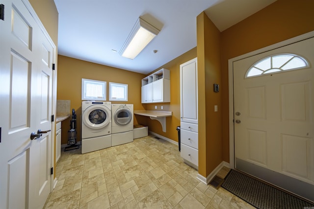 505 E Tri Lks, Horseshoe Bend, AR 72512 - laundry area featuring washer and clothes dryer, light stone finish floors, baseboards, and cabinet space