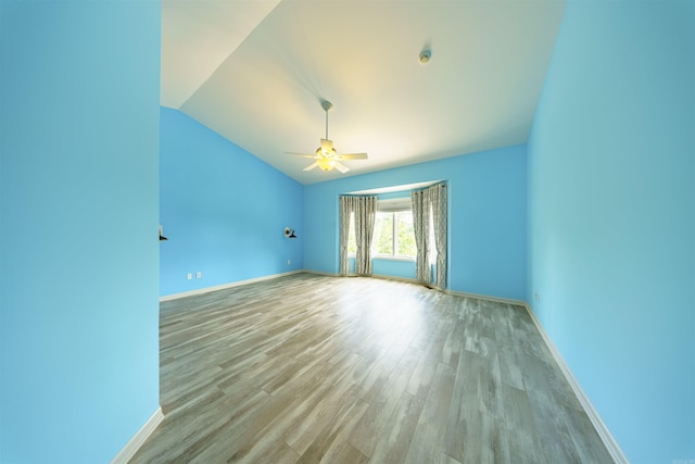 505 E Tri Lks, Horseshoe Bend, AR 72512 - unfurnished room with a ceiling fan, wood finished floors, baseboards, and vaulted ceiling